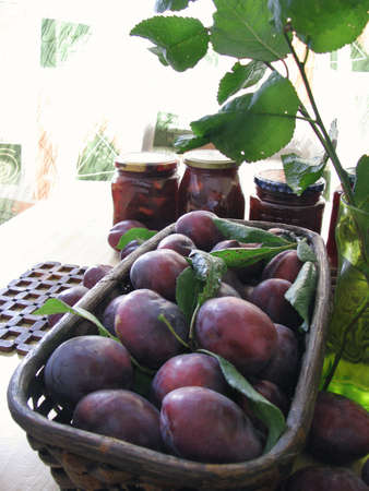 Ripe plums in a basketの写真素材