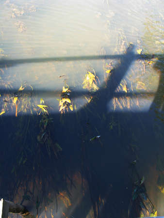 Shadow from the bridge on the river waterの写真素材