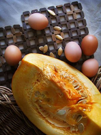 Still life with a pumpkin and eggsの写真素材