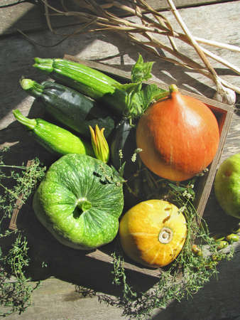Colorful ripe vegetables in a wooden box on a wooden backgroundの写真素材