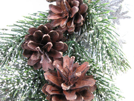 Christmas wreath of pine cones and branches, covered with decorative snow on a white background. Winter holiday Xmas and New Yearの写真素材