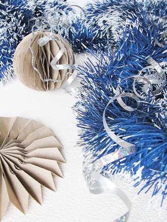 Merry Christmas and happy winter holiday. Blue and white garland, paper balls on the Christmas tree. Christmas decorations on a light backgroundの写真素材