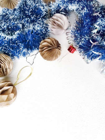 Merry Christmas and happy winter holiday. Blue and white garland, paper balls on the Christmas tree, and Christmas decorations on a light backgroundの写真素材