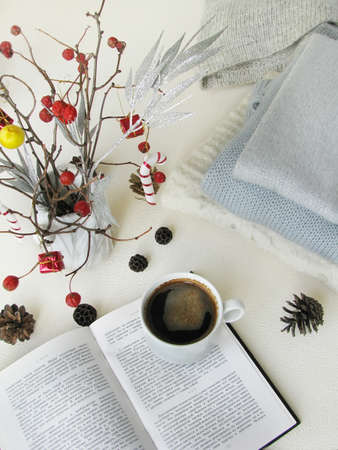 Christmas and happy winter holiday. Warm cozy home. Christmas decorations, soft knits, and a cup of coffee on a light background. View from aboveの写真素材