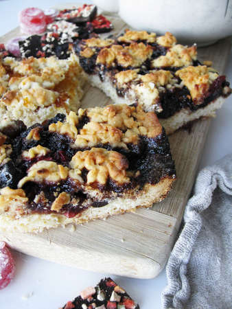 Pieces of pie with jam on a wooden boardの写真素材