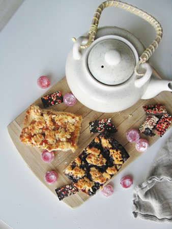 Shortbread dough pie with jam and ceramic teapotの写真素材