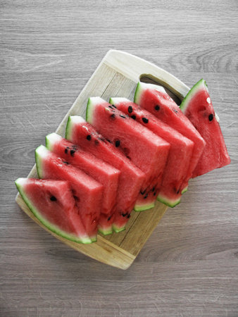 Sliced watermelon on a wooden boardの写真素材