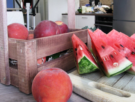 Sliced watermelon and peaches on the tableの写真素材
