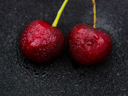 perfect ripen cherries against black background on black background.