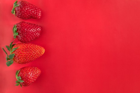 Strawberry on red background tasty postcard paperの写真素材