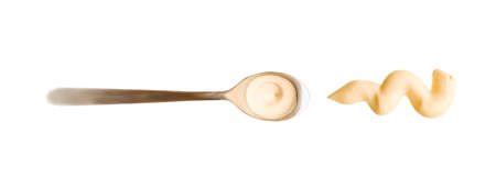 Mayonnaise drop in the spoon. Top view of sause splash isolated on white background. High reolution photography.の写真素材