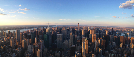 Scenic panorama of metropolis urban cityscape on sunsetの写真素材