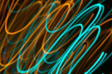 Blurred moving diagonal LED lights, festive abstract color background. Blue and yellow.の写真素材