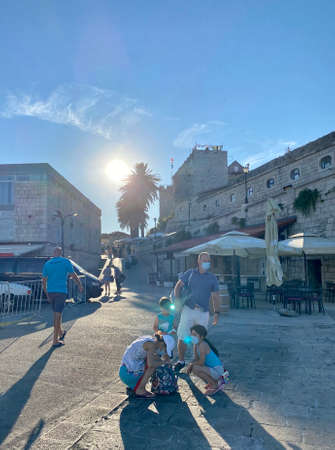 Korcula, Croatia - July 28 2020: Family travelling during COVID-19 pandemic with face masks in Croatiaのeditorial素材