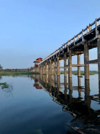 Amarapura, Myanmar - November 6, 2019: U Bein Bridge across the Taungthaman Lake in Amarapura