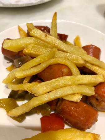 Traditional spanish tapas with chorizo sausage and french friesの写真素材