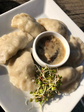 Pierogi, a traditional Polish dumpling, with mushroom sauceの写真素材
