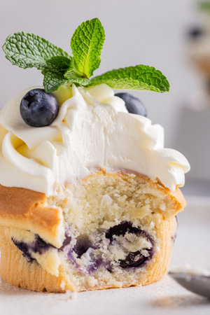 Blueberry Muffin with whipped cream and fresh blueberries.の写真素材