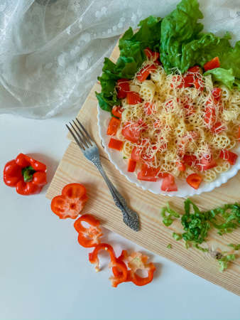 Italian pasta with cheese and vegetables on the white backgroundの写真素材