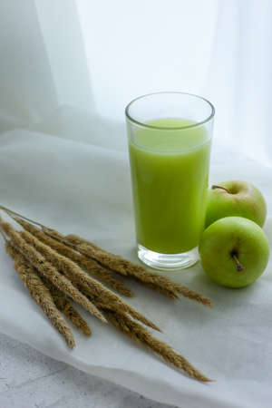 Apple smoothie and apple on white backgroundの写真素材