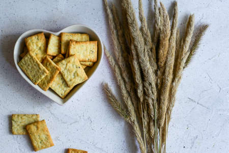 diet italian crackers and wheat ears on white backgroundの写真素材