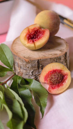homemade tender peaches on a pink backgroundの写真素材