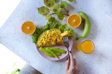 omelet with orange juice and fresh fruitの写真素材