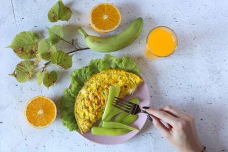 omelet with orange juice and fresh fruitの写真素材