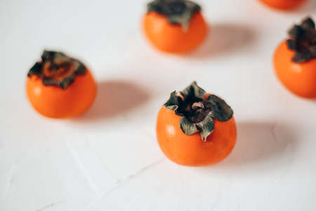 orange persimmon on a light background