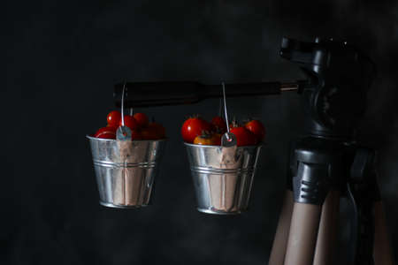 two buckets of cherry tomatoes on a dark backgroundの写真素材