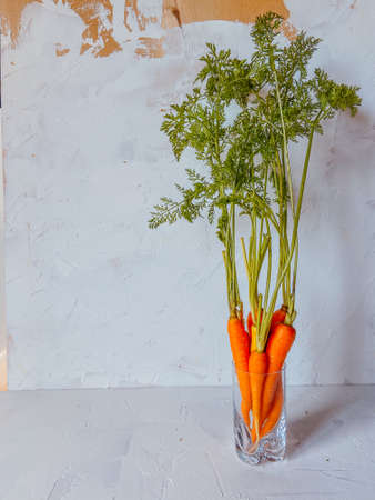 carrots with glass beaker on white backgroundの写真素材