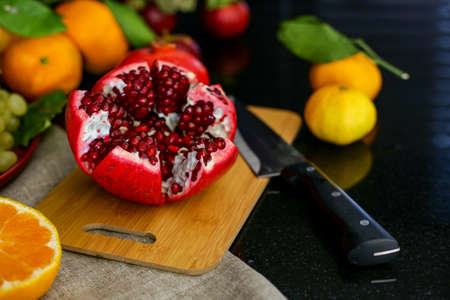 Bright and juicy pomegranate and fruits on the tableの写真素材