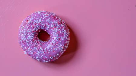 pink donut in glaze on pink background