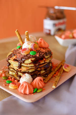 Homemade delicious pancakes with chocolate and sweetsの写真素材