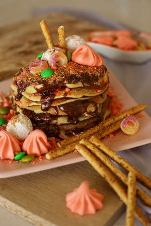 Homemade delicious pancakes with chocolate and sweetsの写真素材
