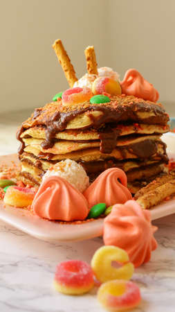Homemade delicious pancakes with chocolate and sweetsの写真素材