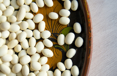 white beans in a beautiful wooden plate