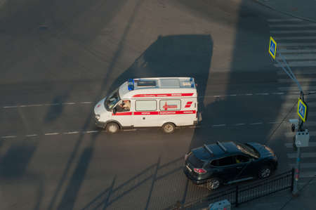 Red and white ambulance car on the street.