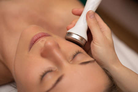 Close-up Of Woman Getting Facial Hydro Microdermabrasion Peeling Treatment At Cosmetic Beauty Spa...