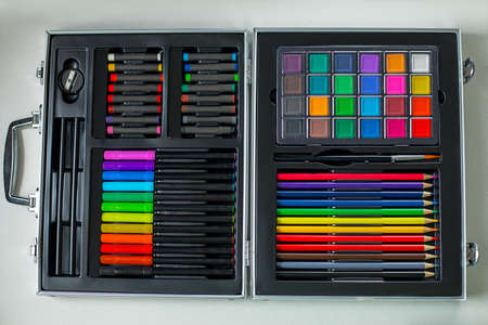 pencils markers paints crayons sharpener great set of schoolboy. we are preparing for the beginning of the school year. All the accessories are stacked in perfect order in the suitcase. Close up Photoの写真素材