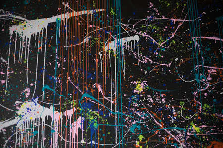 Abstract Multi-colored paint splashes on a black background.の写真素材