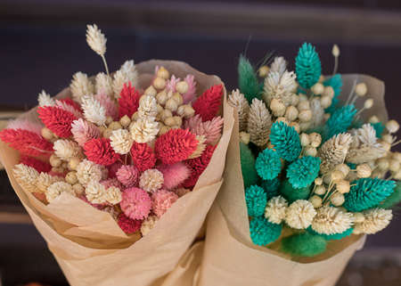 Autumn bouquet of colored dried flowers. Pink and blue shades. Flower shop, florist. Close up photoの写真素材