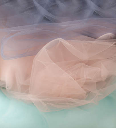 background of tulle type fabric of three delicate shades, gray, blue pink. Copy space for your text. splash screen for blog design, social networks. Close up photoの写真素材