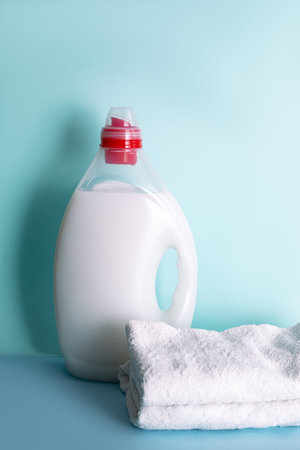 Laundry Detergent in bottle with Liquid and towels on a blue background. Washing or whitening conceptの写真素材