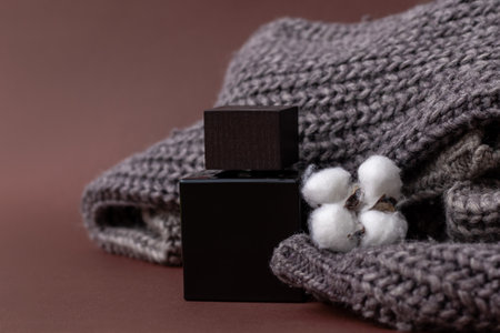 Perfume, Men's perfume or lation After shave on a brown background next to a men's sweater and a...