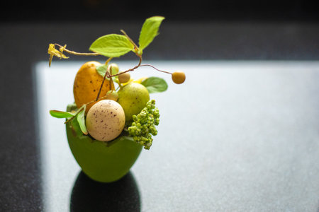 modern handmade composition of eggs and green branches on black background with window reflections. Copy space. Easter conceptの写真素材