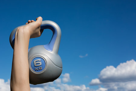 kettlebell against the sky with cloud in hand, copy spaceの写真素材