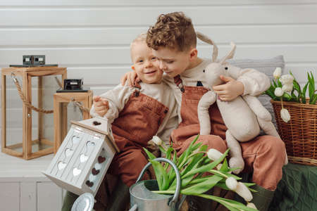 Two brothers on veranda hugging together spring summer time friendship relationship emotions