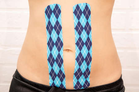 special physio tape put on injured abdomen over white background