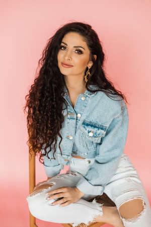 Girl student with beautiful long curly hair looking at camera. online education concept